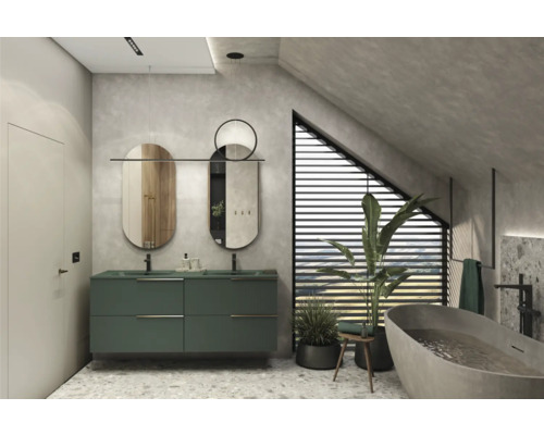 Salle de bains moderne avec meuble-lavabo vert, deux miroirs et baignoire îlot sous une pente de toit.