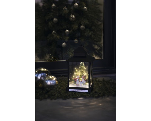 Lanterne décorative avec motif bonhomme de neige et sapin de Noël en arrière-plan