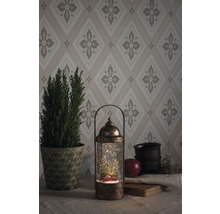 Lanterne décorative boule à neige avec motif de Noël et éclairage LED sur une table