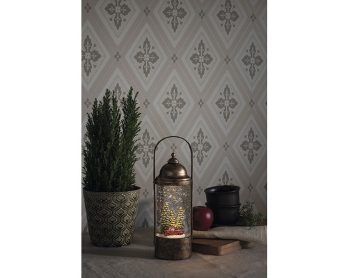 Lanterne décorative boule à neige avec motif de Noël et éclairage LED sur une table