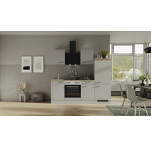 Cuisine intégrée claire avec hotte aspirante et cuisinière électrique dans un intérieur moderne.