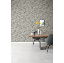 Esszimmer mit Esstisch, Stühlen und gemusterter Tapete mit Blättern