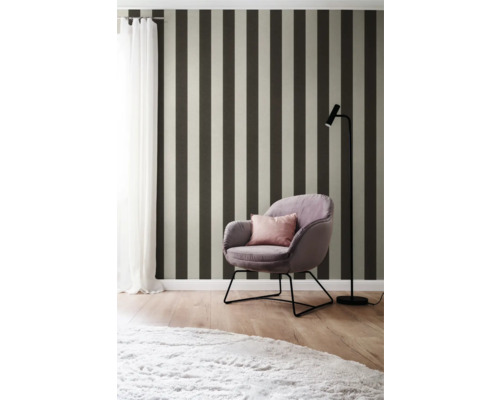 Einrichtungsidee mit gestreifter Tapete, Sessel und Stehlampe für ein stilvolles Ambiente.