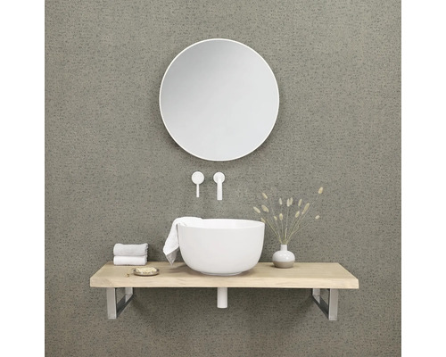 Salle de bains moderne avec miroir rond, lavabo et robinetterie