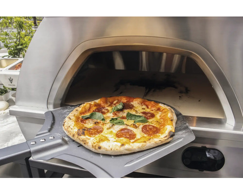 Pizza auf einem Pizzaschieber vor einem Pizzaofen