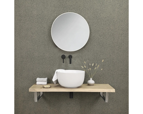 Salle de bains moderne avec miroir rond, vasque à poser, plan de toilette et robinetterie