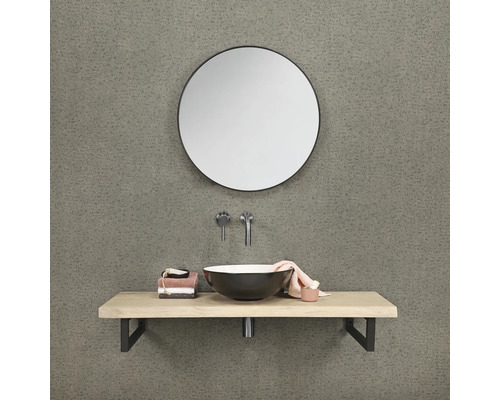 Salle de bains avec miroir rond, plan de toilette et lavabo à poser