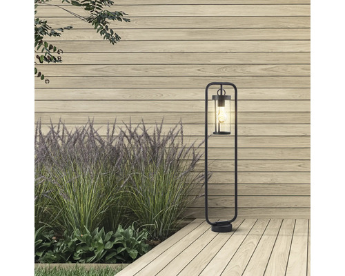 Aussenbereich mit Stehleuchte, Holzzaun und Pflanzen.