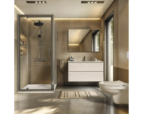 Salle de bains moderne avec douche, lavabo, miroir et toilettes.