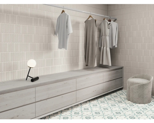 Dressing lumineux avec mur carrelé, commode, tabouret et tringle à vêtements avec vêtements
