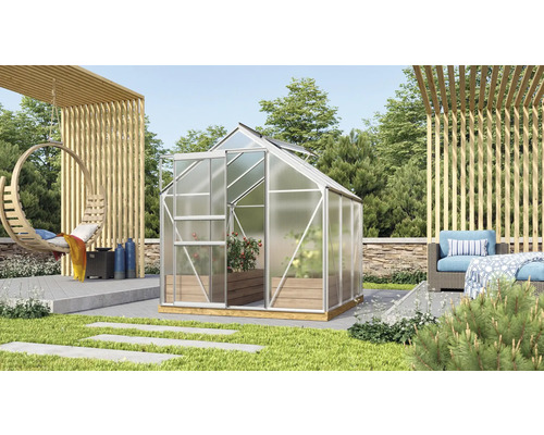 Serre avec cadre en aluminium et plantes dans le jardin.