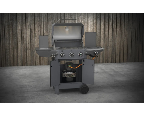 Grill à gaz avec couvercle ouvert et bouteille de gaz dans le meuble bas