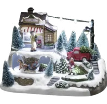 Dekorative Weihnachtsszene mit Figuren, Haus, Tannenbäumen und Beleuchtung