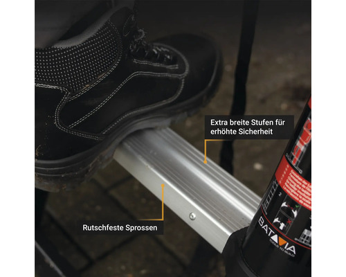 Detailaufnahme einer Leiter mit breiten, rutschfesten Stufen unter einem Fuss in einem Sicherheitsschuh