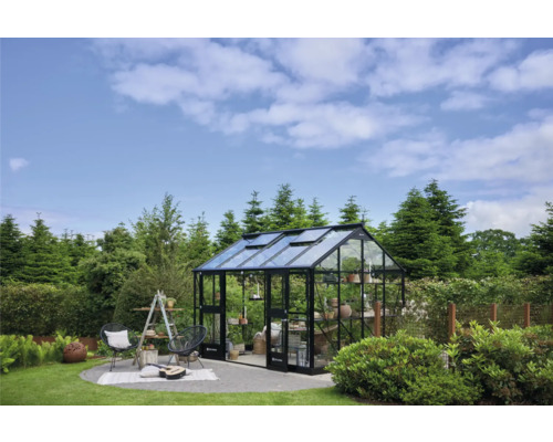 Serre de jardin avec coin salon et étagères plantées