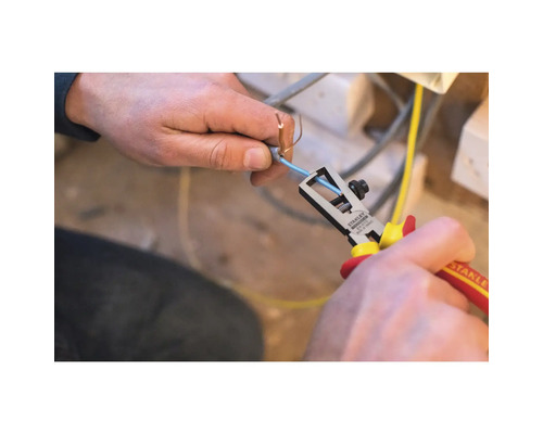 Eine Person mit einer Stanley Abisolierzange entfernt die Isolierung von einem Kabel.
