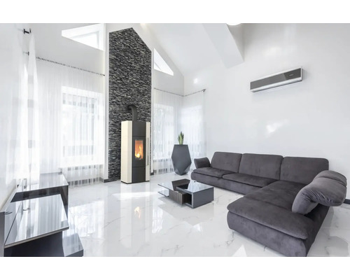 Helles Wohnzimmer mit Kaminofen, Sofa und Klimaanlage