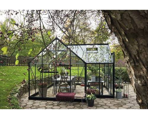 Serre avec verre et cadre métallique dans le jardin