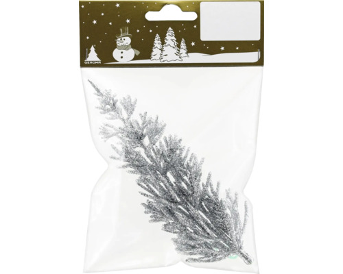 Branche de sapin scintillante dans un emballage comme décoration de Noël