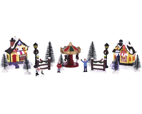 Scène de village de Noël avec carrousel, maisons, personnages et arbres
