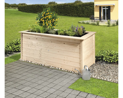 Jardinière en bois avec plantations et arrosoir dans le jardin