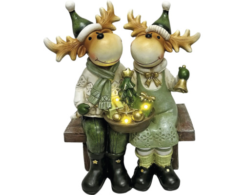 Des figurines décoratives d''élans avec éclairage LED et motifs de Noël sont assises sur un banc.