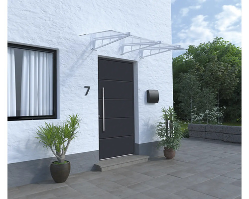 Porte d''entrée avec auvent, boîte aux lettres et plantes en pot devant une maison.