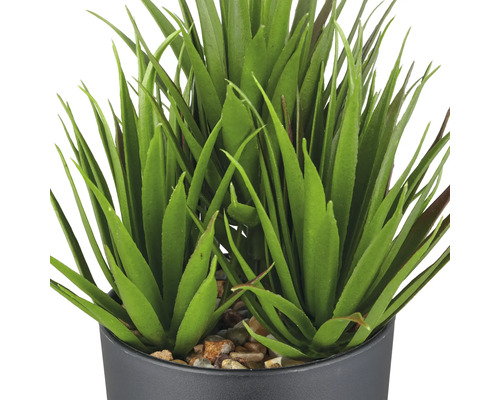 Plante verte artificielle en pot avec pierres décoratives