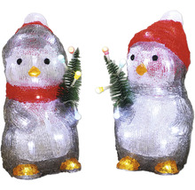 Zwei dekorative Pinguine mit Mütze und Tannenbaum