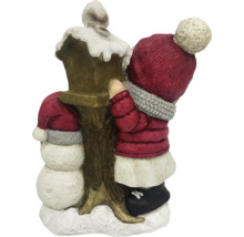 Décoration de Noël avec bonhomme de neige et enfant près d''une lanterne