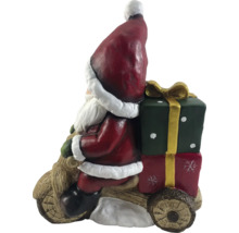 Figurine de Père Noël sur une moto en bois avec des cadeaux