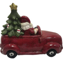 Weihnachtsdekoration: Weihnachtsmann fährt mit Weihnachtsbaum im Auto