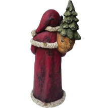 Figurine de Père Noël avec arbre dans un sac