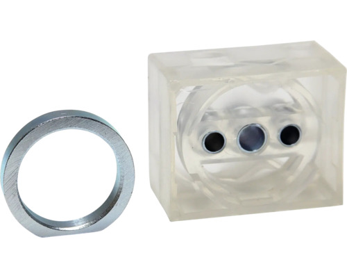 Metallring und durchsichtiger Quader mit Bohrungen