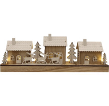 Paysage d''hiver décoratif avec maisons, arbres et cerfs en bois