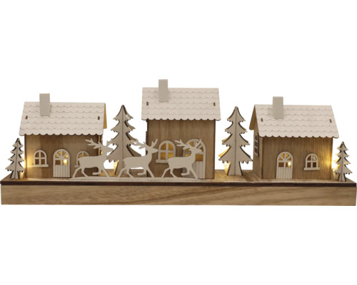 Paysage d''hiver décoratif avec maisons, arbres et cerfs en bois
