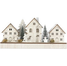 Décoration de Noël avec maisons, arbres, traîneau et bonhomme de neige