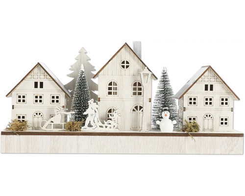 Décoration de Noël avec maisons, arbres, traîneau et bonhomme de neige