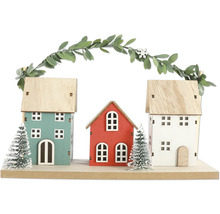 Dekorative Häuserreihe aus Holz mit Girlande und kleinen Tannenbäumen