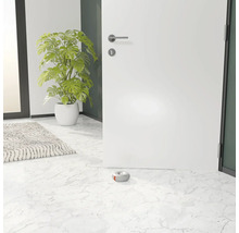 Une porte blanche ouverte avec un butoir de porte gris sur un sol en marbre