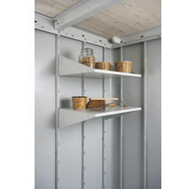 Deux étagères avec outils de jardin et décoration dans une cabane de jardin.
