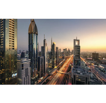 Vue panoramique de la skyline de Dubaï avec des gratte-ciel illuminés et la circulation routière au crépuscule.