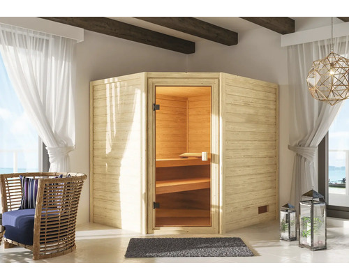 Sauna en bois massif Karibu Elea sans poêle ni couronne avec porte entièrement vitrée couleur bronze Vue intérieure avec un sauna en bois, un fauteuil en rotin et des lanternes décoratives.
