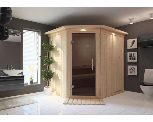 Salle de bains avec sauna d'angle en bois avec porte en verre, lavabo et toilettes