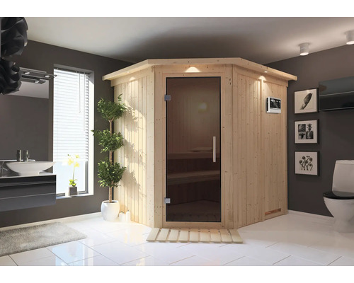 Elementsauna Karibu Petalit inkl. 9 kW Bio Ofen u. ext. Steuerung mit Dachkranz Badezimmer mit Ecksauna aus Holz, Waschtisch und Toilette.