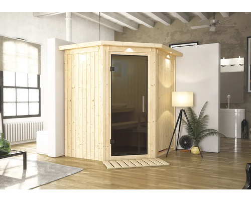 Sauna en bois avec porte en verre dans une pièce lumineuse
