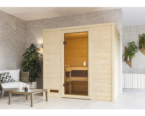 Sauna Woodfeeling Selena inkl.3,6 kW Ofen u.integr.Steuerung ohne Dachkranz mit bronzierter Ganzglastüre Holzsauna mit Glastür in einem hellen Raum