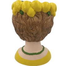 Jardinière décorative en forme de tête de femme avec décorations de citrons