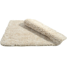 Beige Badematte, teilweise aufgerollt