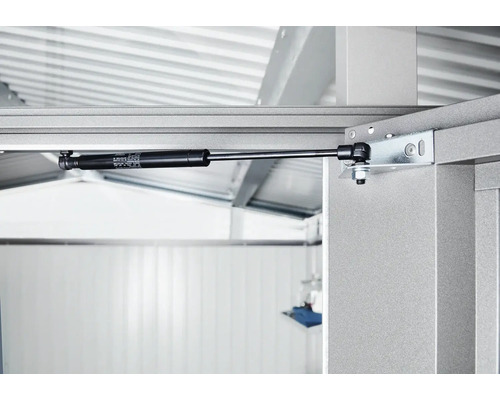 Detailaufnahme eines Gasdruckdämpfers an einem Metallrahmen.